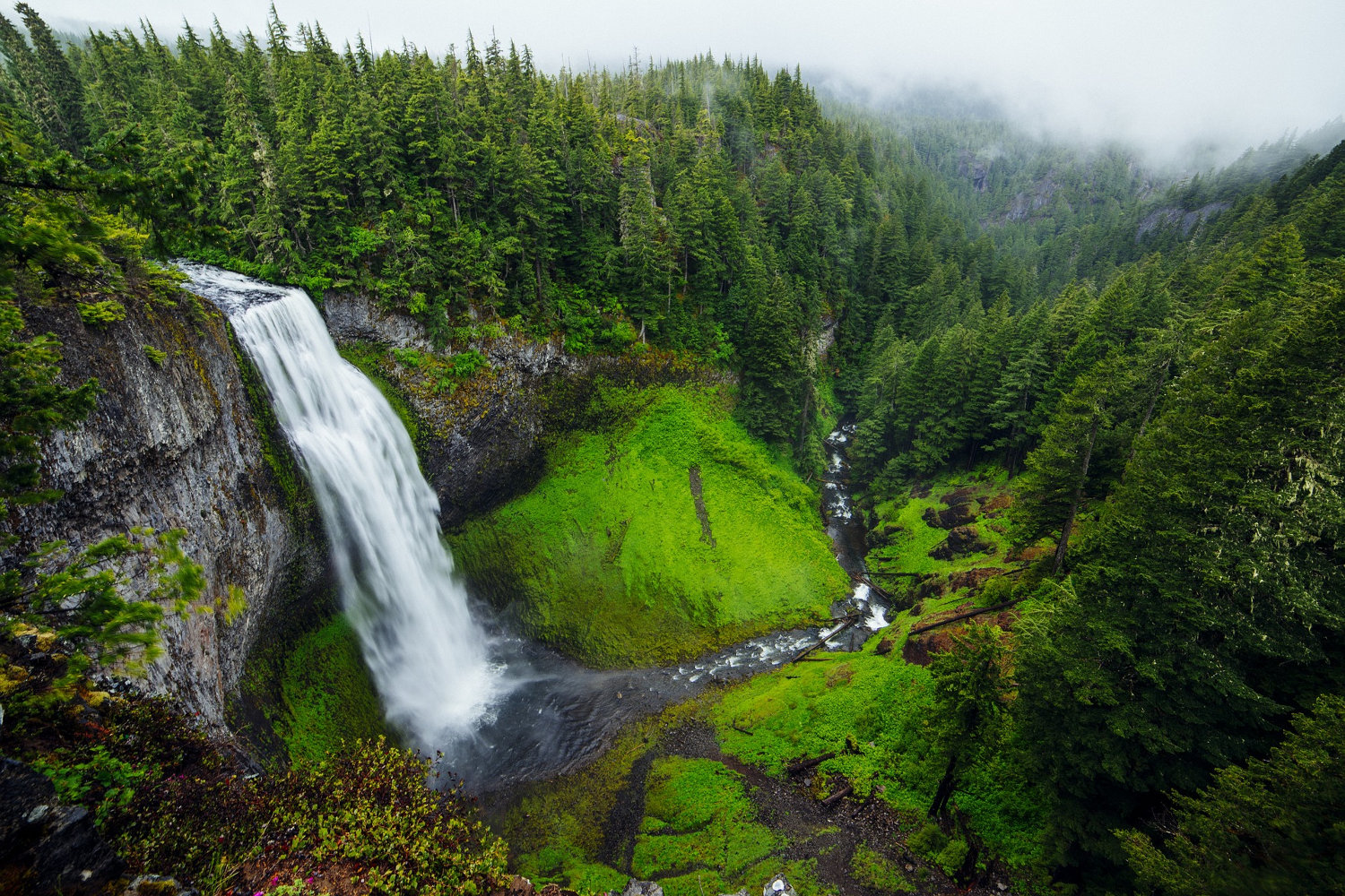 Waterfall with luxurious forest and a local valley